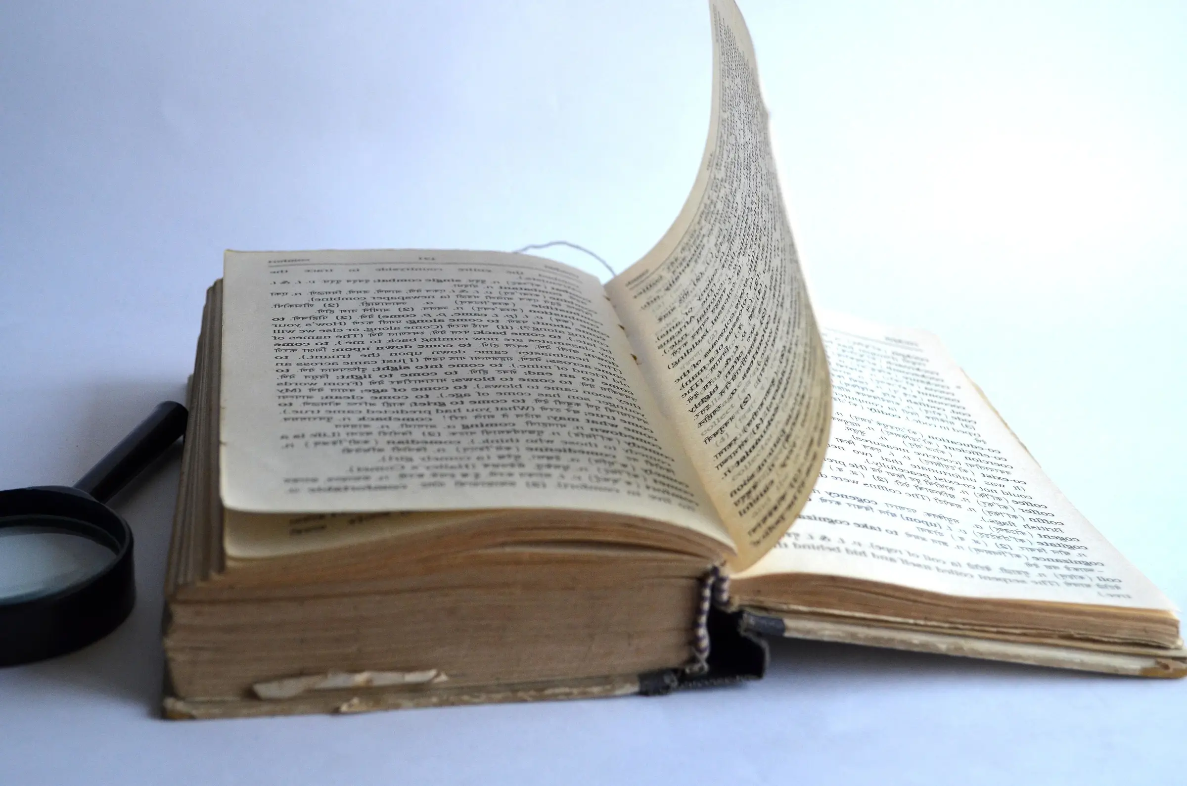 The page of an old book caught mid-turn
